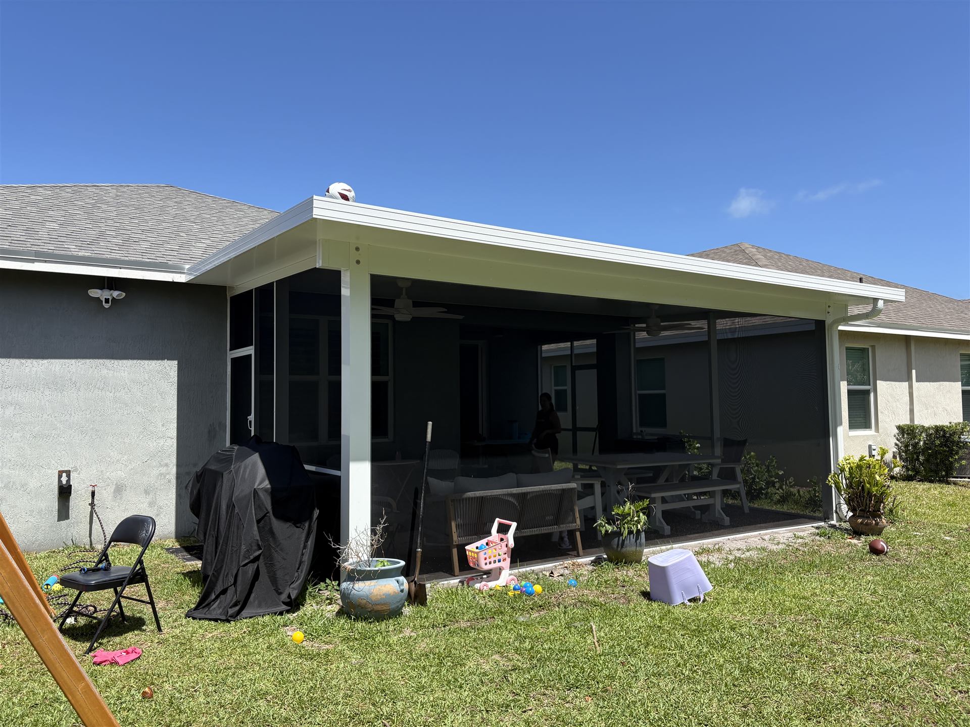 Screen enclosure exterior with outdoor kitchen underneath