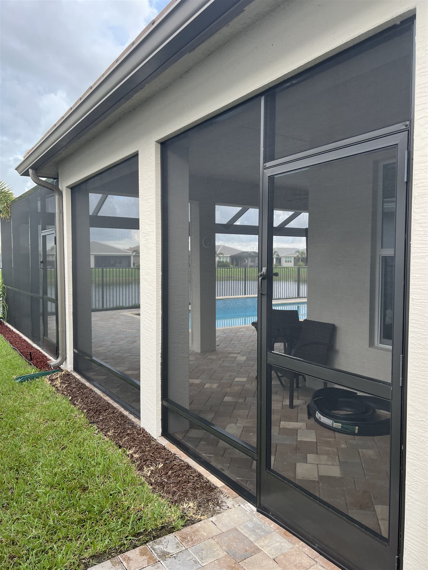 Screened enclosure with pool view and screen door detail