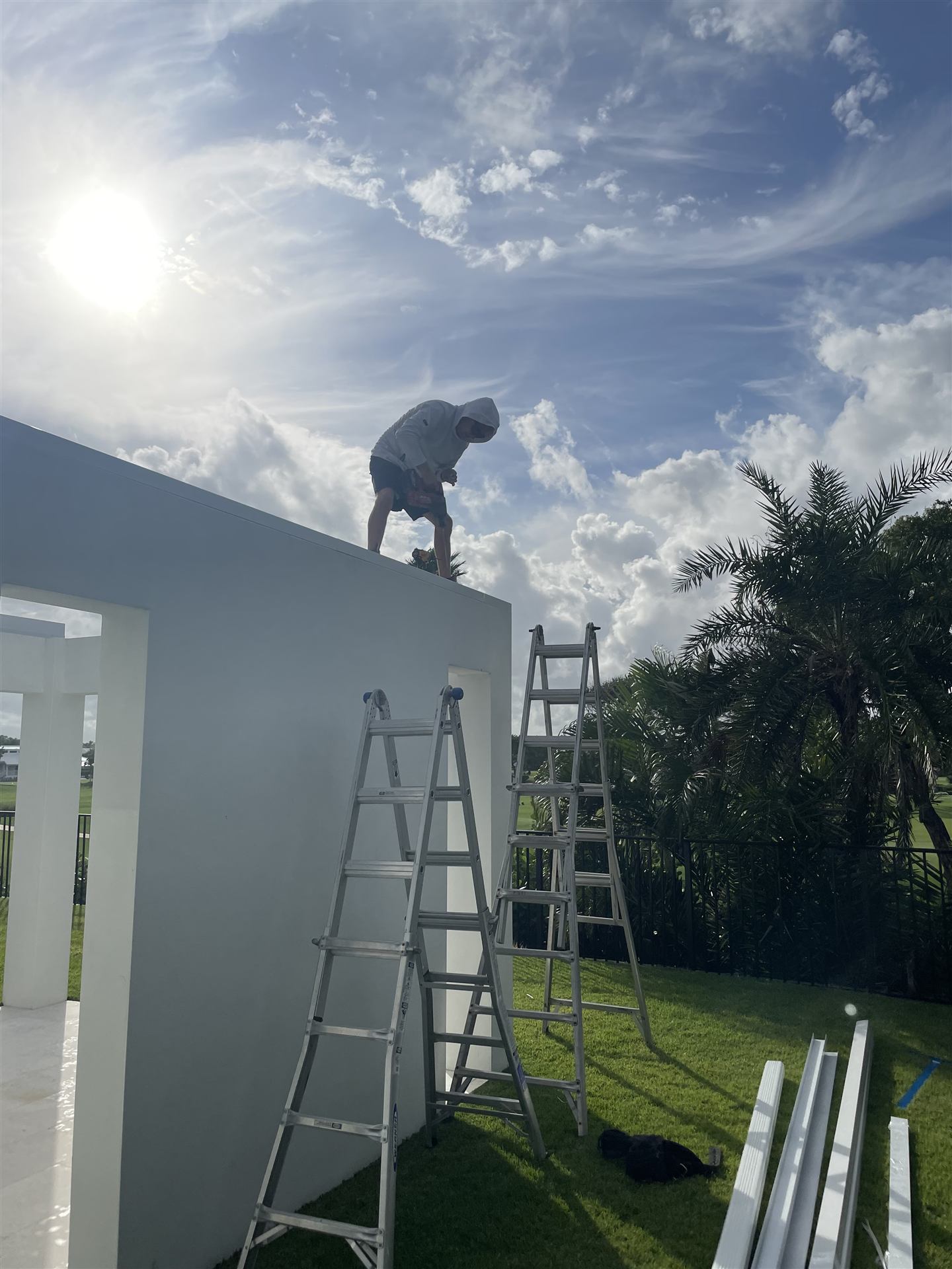Big Al's Aluminum crew member on a ladder at a job site